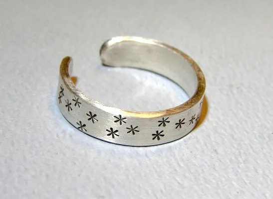 Adjustable star stamped sterling silver ring