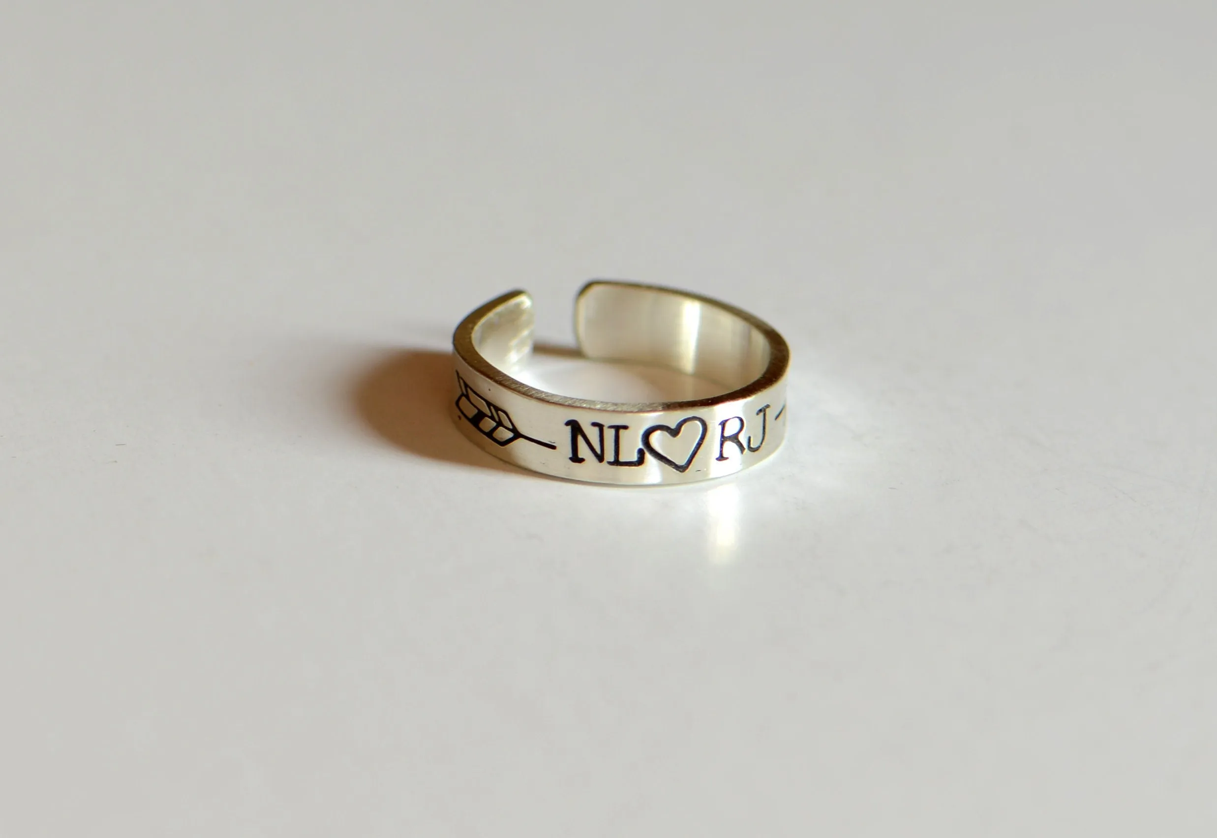 Sterling silver customized toe ring with initials framed by arrow