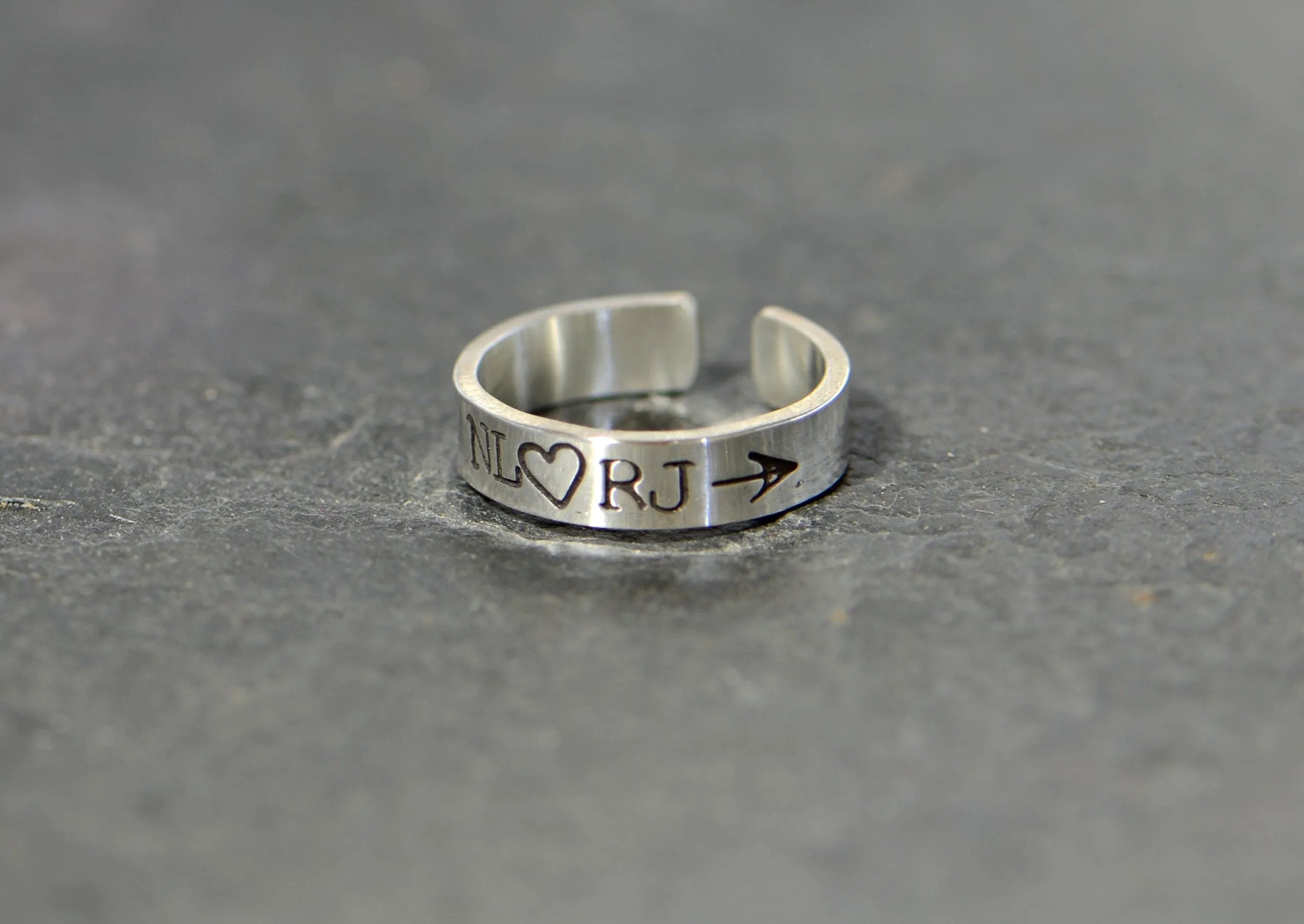Sterling silver customized toe ring with initials framed by arrow