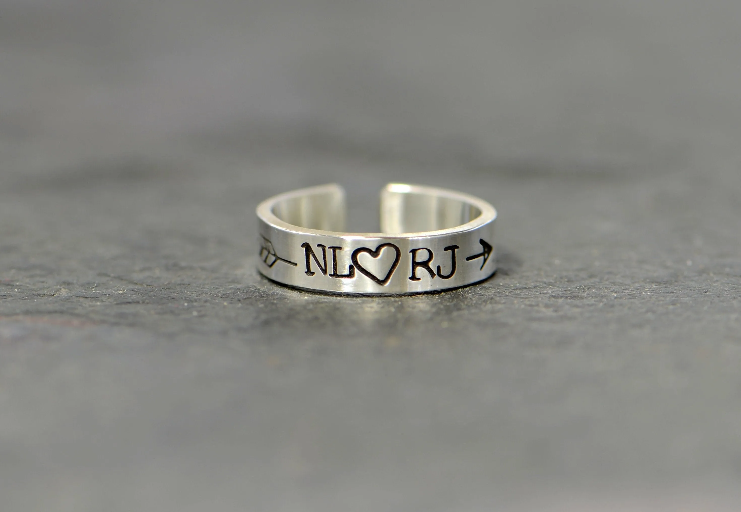 Sterling silver customized toe ring with initials framed by arrow